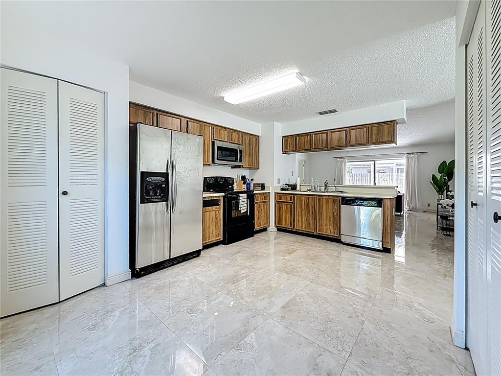 1909 Castle Bay Court Oldsmar, FL 34677 - Photo 18 of 48 a large kitchen with cabinets and stainless steel appliances