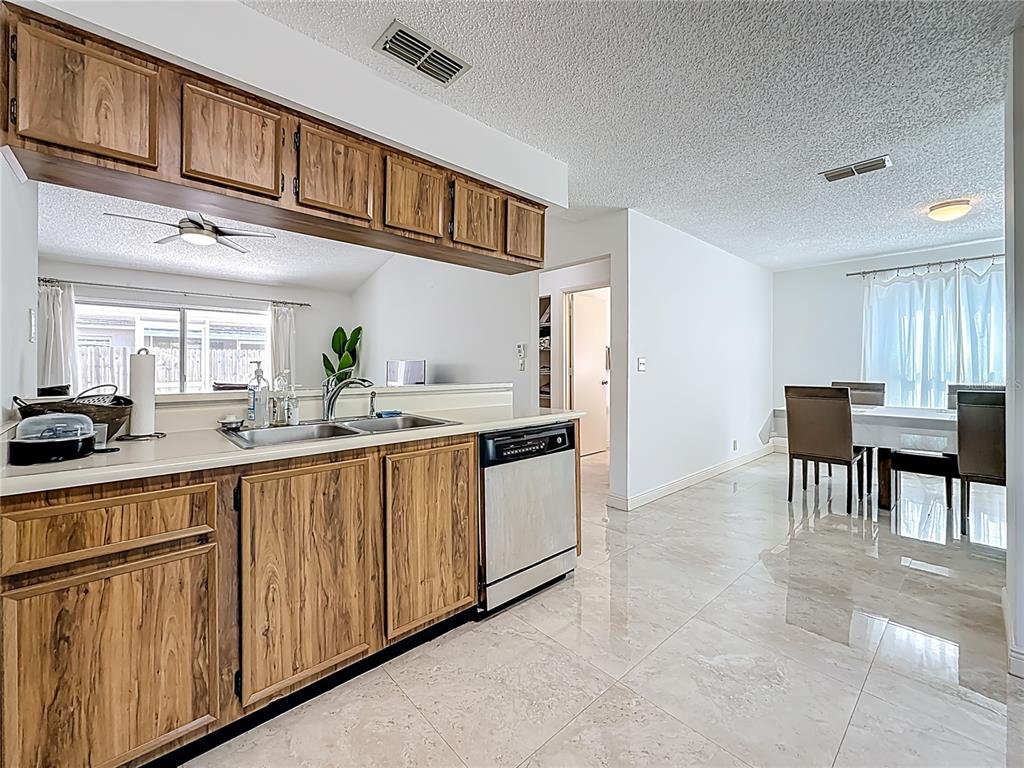 1909 Castle Bay Court Oldsmar, FL 34677 - Photo 20 of 48 a kitchen with stainless steel appliances granite countertop a sink and cabinets