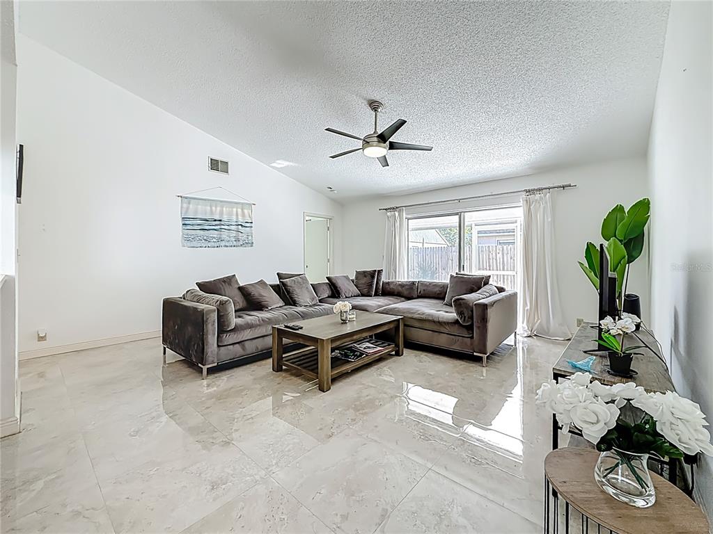 1909 Castle Bay Court Oldsmar, FL 34677 - Photo 2 of 48 a living room with furniture and a potted plant