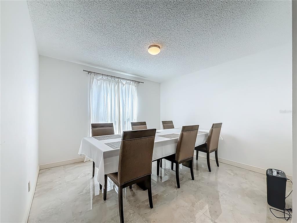 1909 Castle Bay Court Oldsmar, FL 34677 - Photo 23 of 48 a view of a dining room with furniture and window