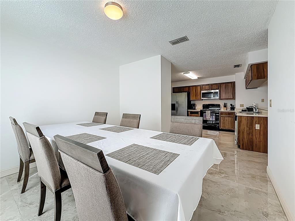 1909 Castle Bay Court Oldsmar, FL 34677 - Photo 24 of 48 a large kitchen with a table and chairs