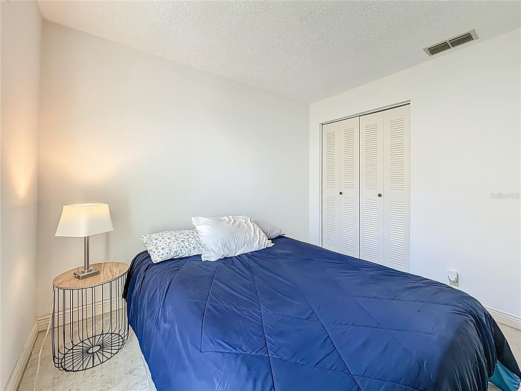 1909 Castle Bay Court Oldsmar, FL 34677 - Photo 27 of 48 a bedroom with a bed and a lamp