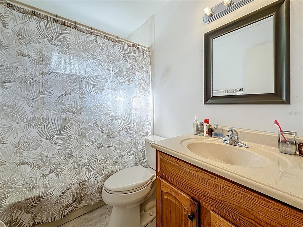 1909 Castle Bay Court Oldsmar, FL 34677 - Photo 30 of 48 a bathroom with a toilet sink and mirror