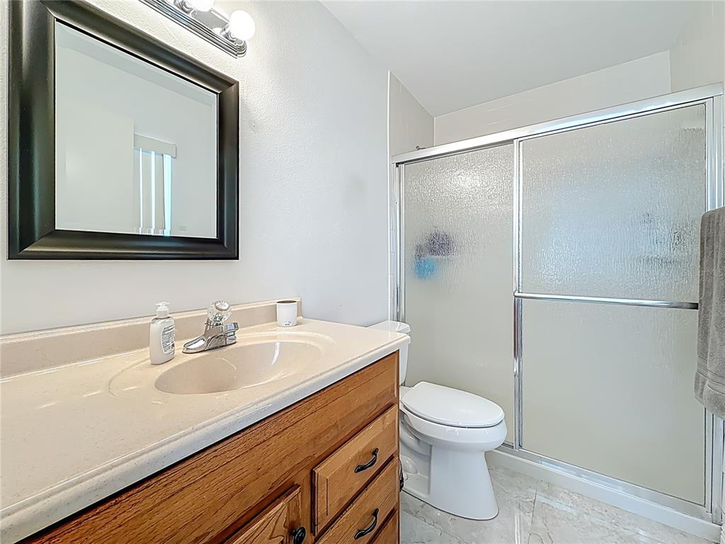 1909 Castle Bay Court Oldsmar, FL 34677 - Photo 33 of 48 a bathroom with a sink toilet vanity and shower