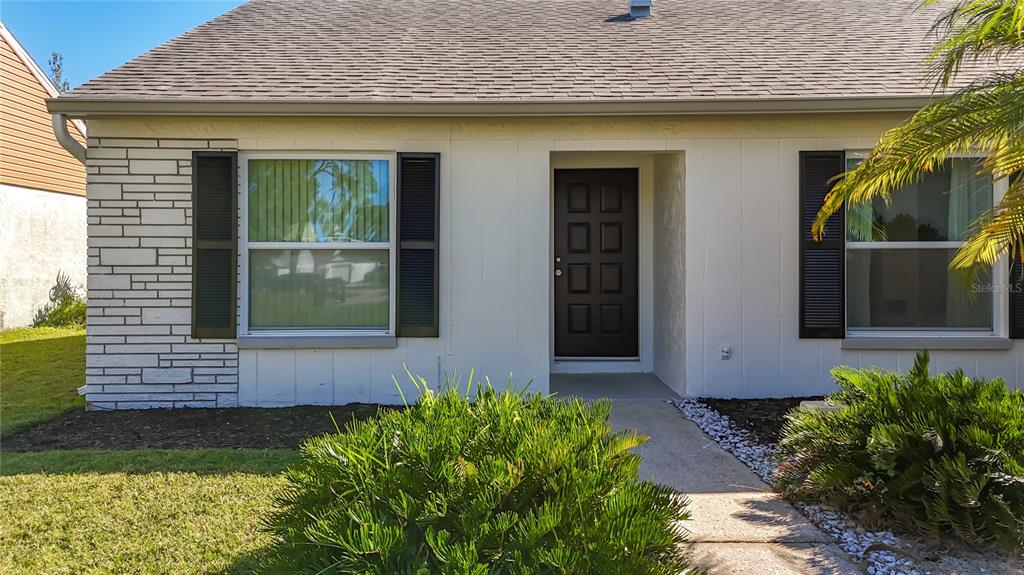 1909 Castle Bay Court Oldsmar, FL 34677 - Photo 43 of 48 a front view of a house with garden