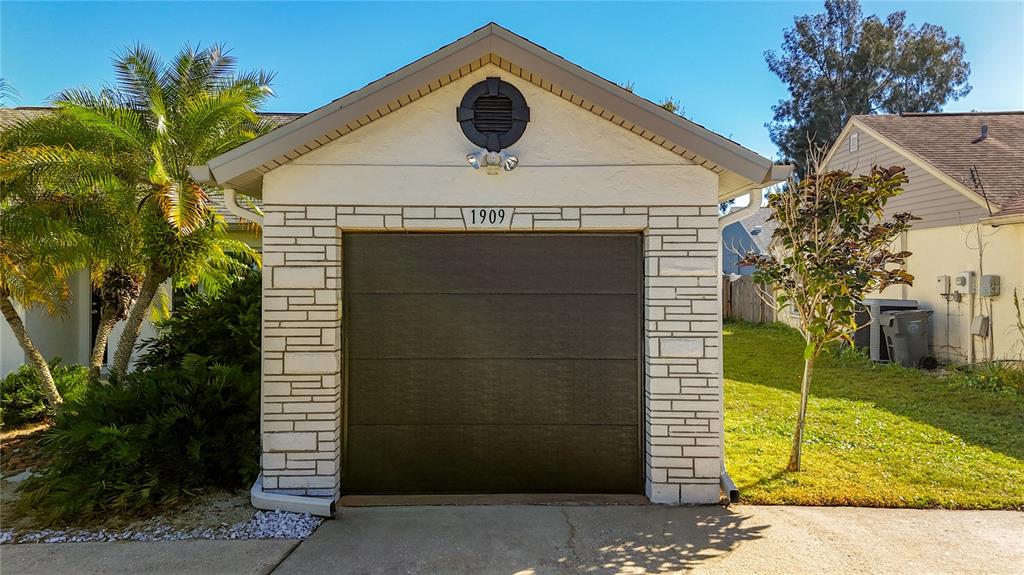 1909 Castle Bay Court Oldsmar, FL 34677 - Photo 44 of 48 a front view of a house with a garden