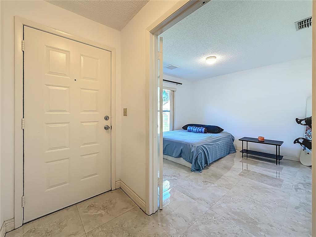 1909 Castle Bay Court Oldsmar, FL 34677 - Photo 9 of 48 a spacious bedroom with a bed and a dresser