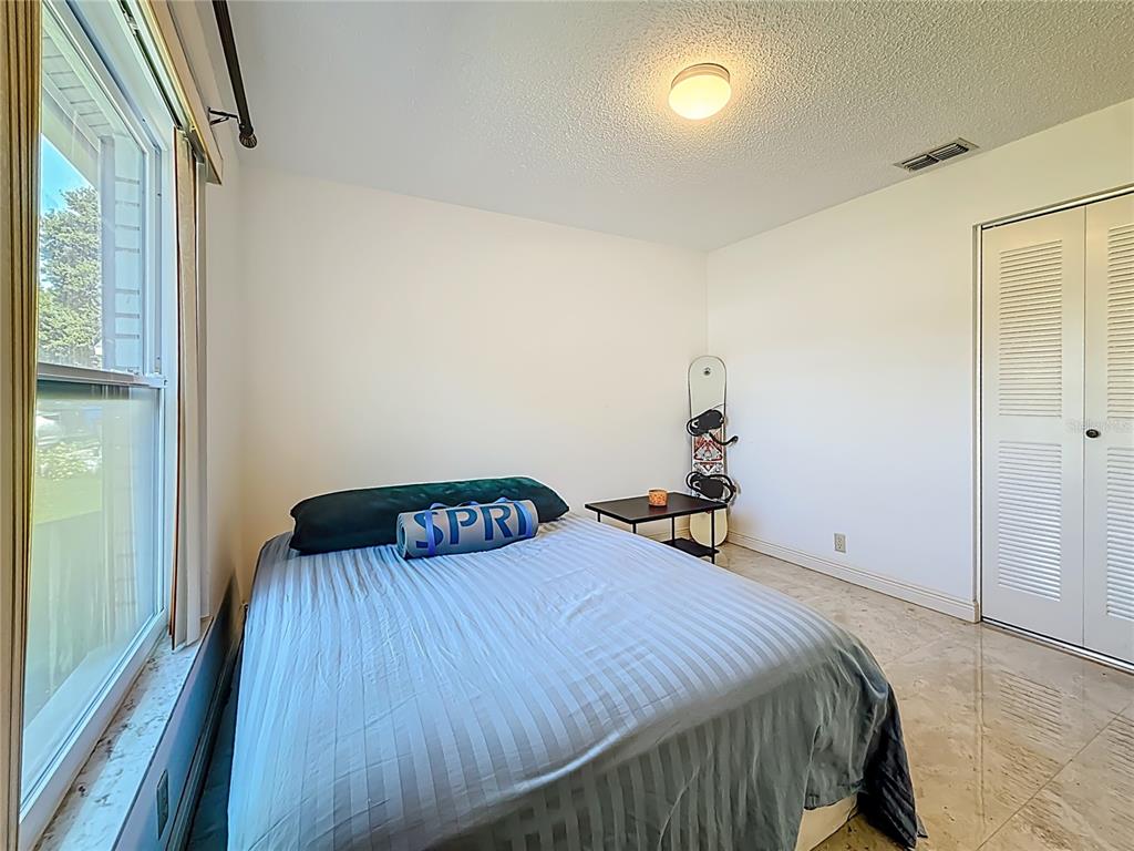 1909 Castle Bay Court Oldsmar, FL 34677 - Photo 10 of 48 a bedroom with a bed and a window