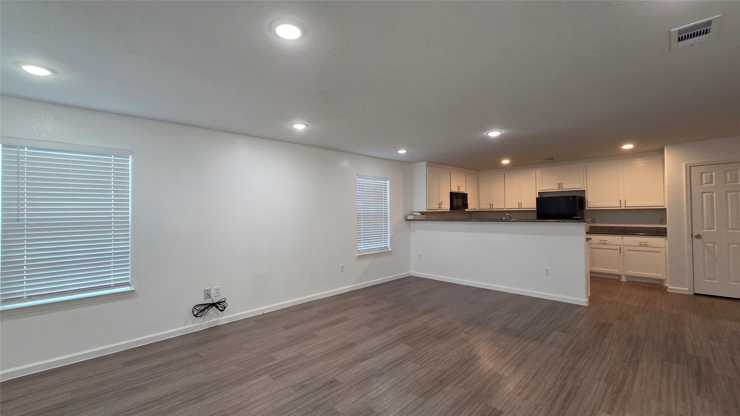 23338 Sandpiper Trail Spring, TX 77373 - Photo 4 of 13 a view of kitchen with kitchen island white cabinets and wooden floor