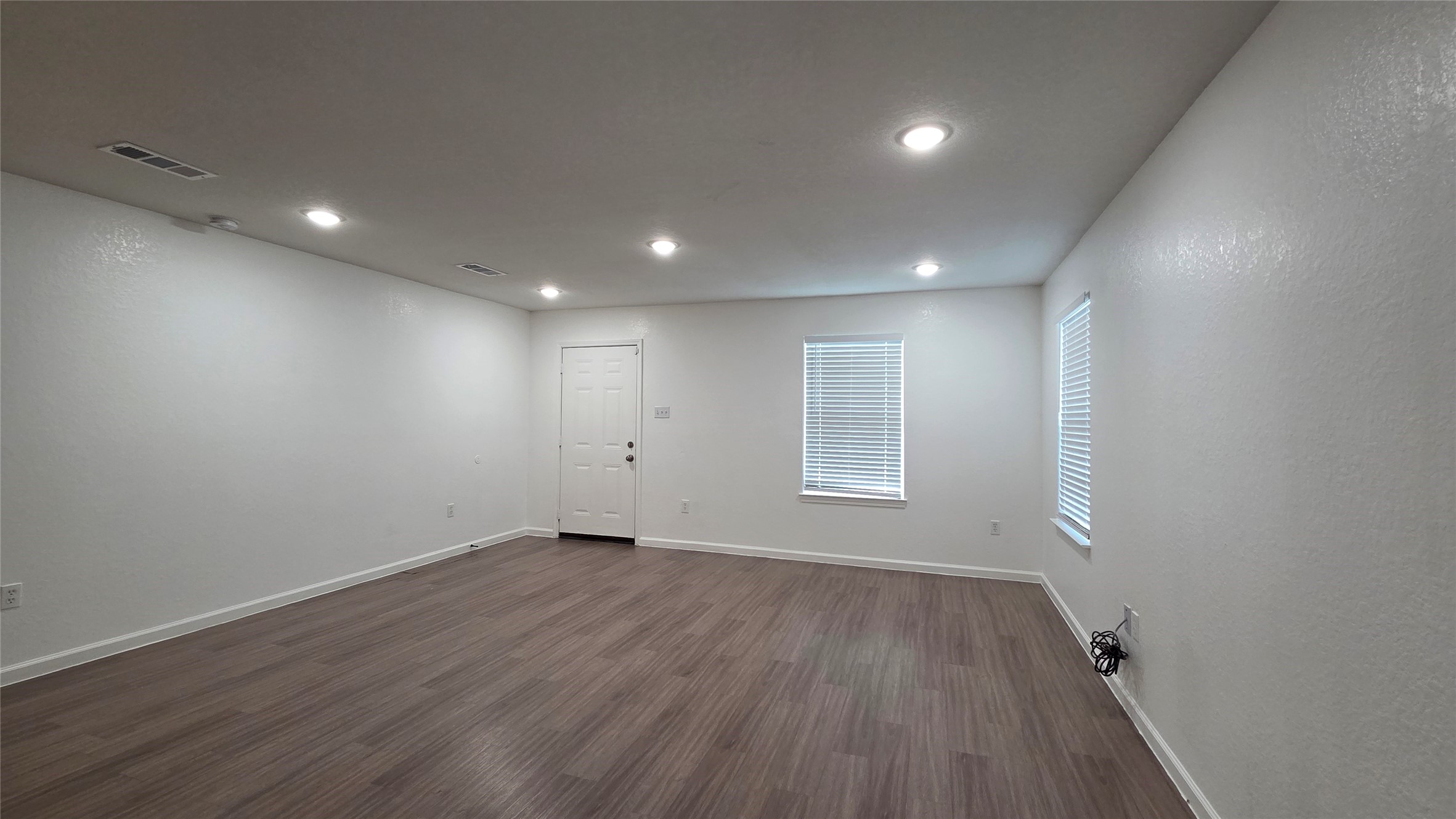 23338 Sandpiper Trail Spring, TX 77373 - Photo 5 of 13 an empty room with wooden floor and windows