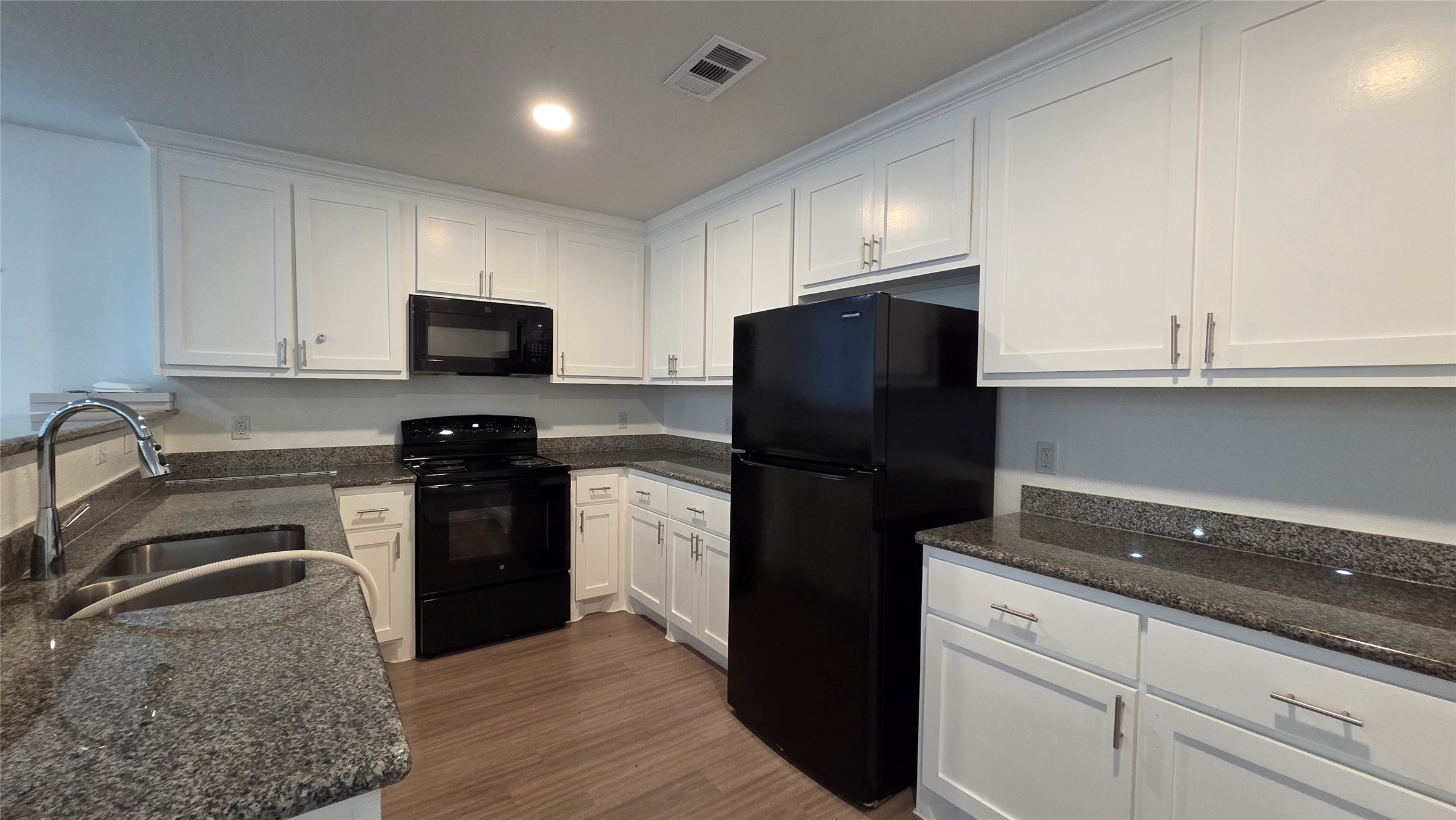 23338 Sandpiper Trail Spring, TX 77373 - Photo 7 of 13 a kitchen with a refrigerator stove and sink