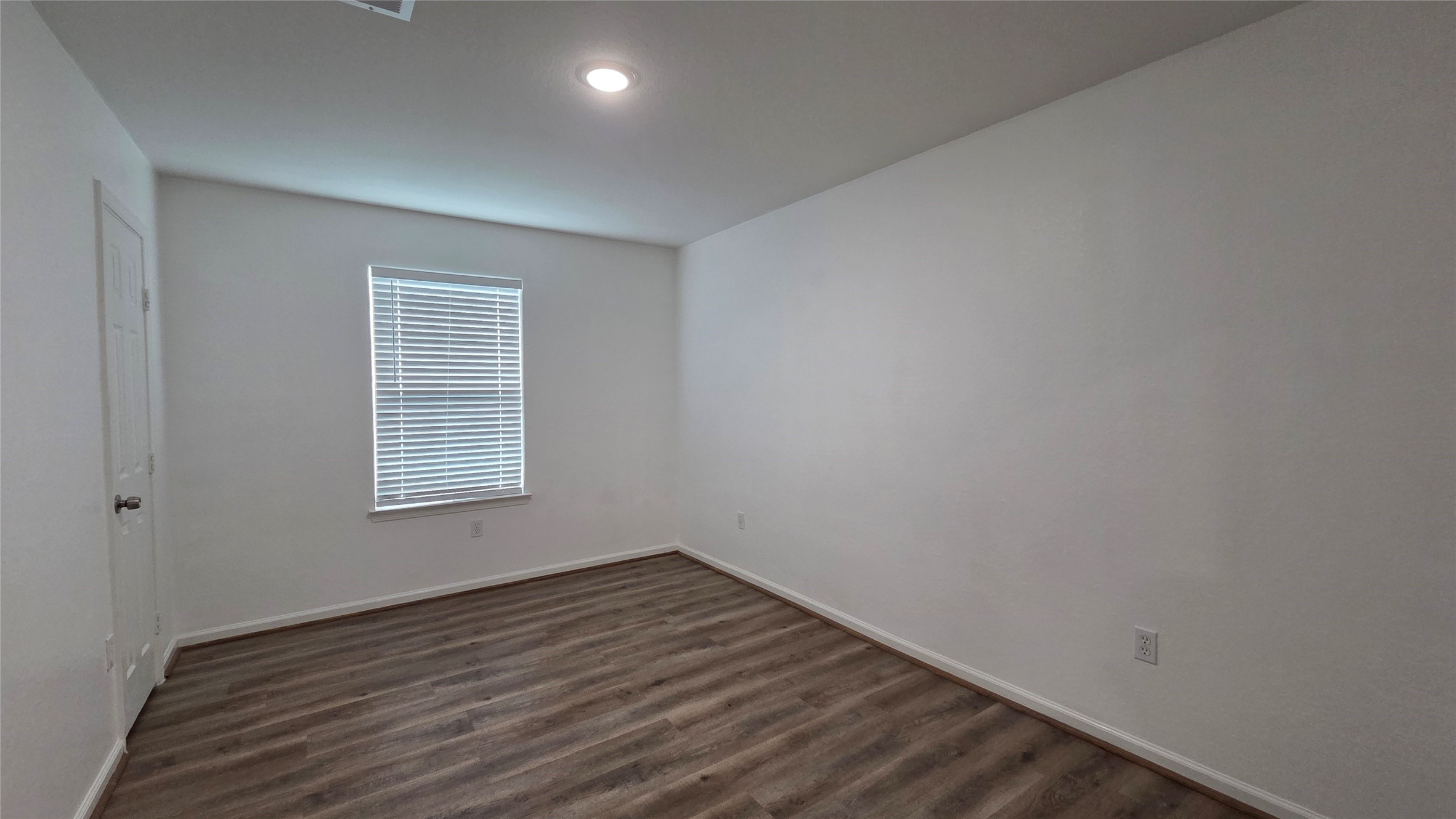 23338 Sandpiper Trail Spring, TX 77373 - Photo 8 of 13 a view of an empty room with wooden floor and a window