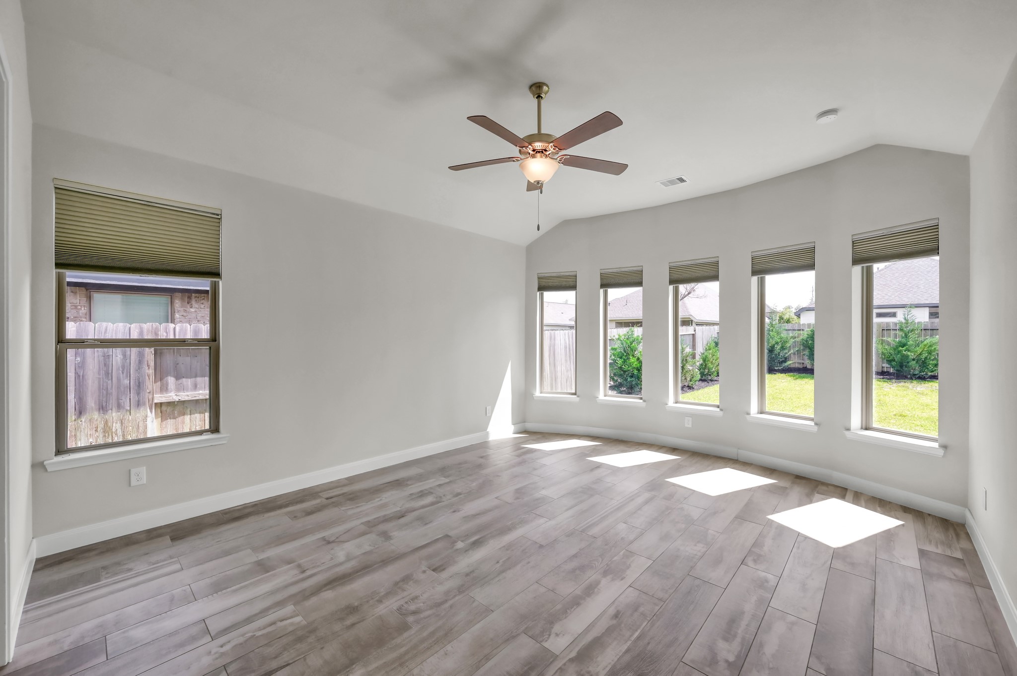 550 Chestnut Reef Court Conroe, TX 77304 - Photo 18 of 46 Spacious primary suite with wall of windows, abundant natural light, and serene backyard views.