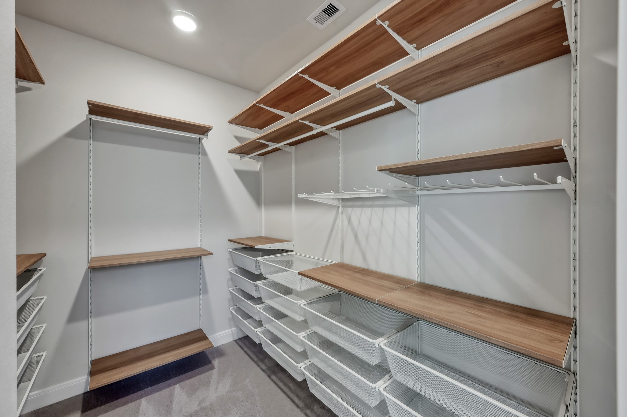 550 Chestnut Reef Court Conroe, TX 77304 - Photo 21 of 46 Spacious walk-in closet with custom shelving and built-in storage system.