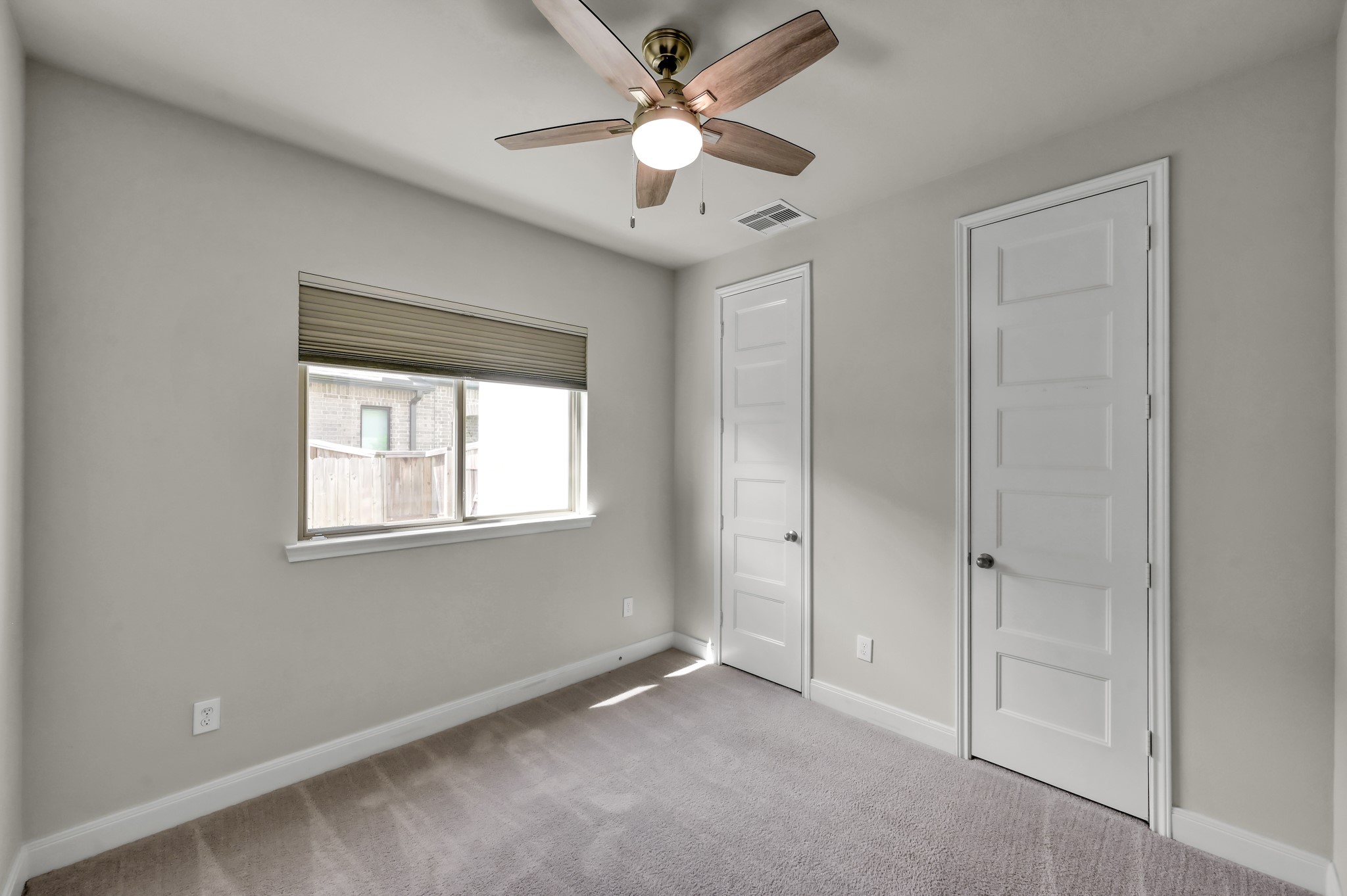550 Chestnut Reef Court Conroe, TX 77304 - Photo 22 of 46 Secondary bedroom down with plush carpeting, ceiling fan, and ample closet space.