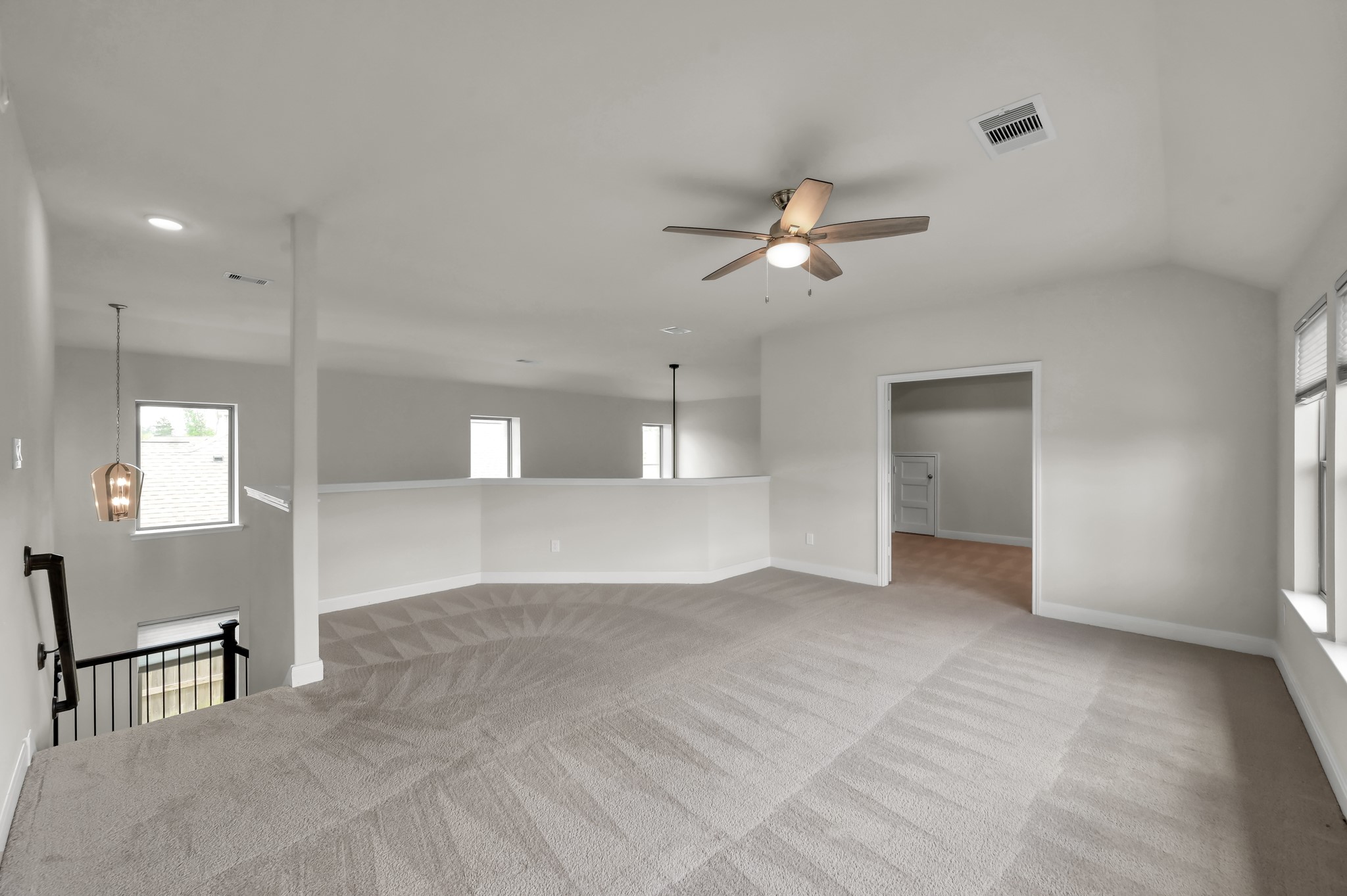550 Chestnut Reef Court Conroe, TX 77304 - Photo 28 of 46 Upstairs game room with connected media room — ideal for movie nights, gaming, and family entertainment.