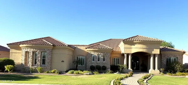 a front view of a house with a garden
