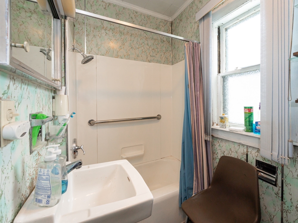 525 Chelmsford Street Lowell, MA 01851 - Photo 13 of 41 a bathroom with a sink and a large mirror