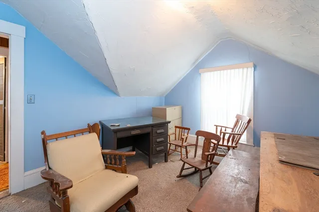a reading room with furniture and a window