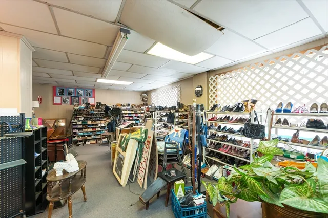 a kitchen with stainless steel appliances kitchen island granite countertop a table chairs and a refrigerator
