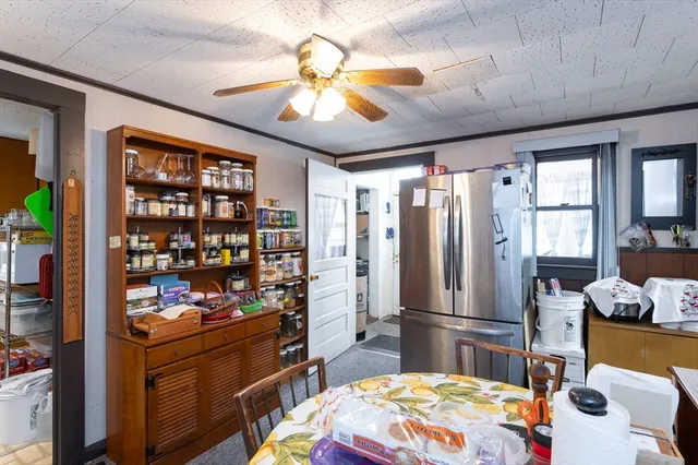 a kitchen with stainless steel appliances kitchen island granite countertop a refrigerator and microwave