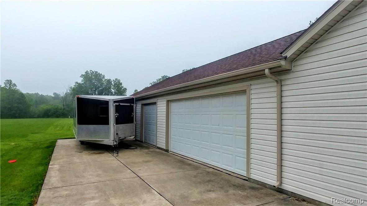 26581 Rinne Road New Boston, MI 48164 - Photo 31 of 35 PARKING PAD ADJACENT TO 5 CAR GARAGE FOR A BOAT OR CAMPER