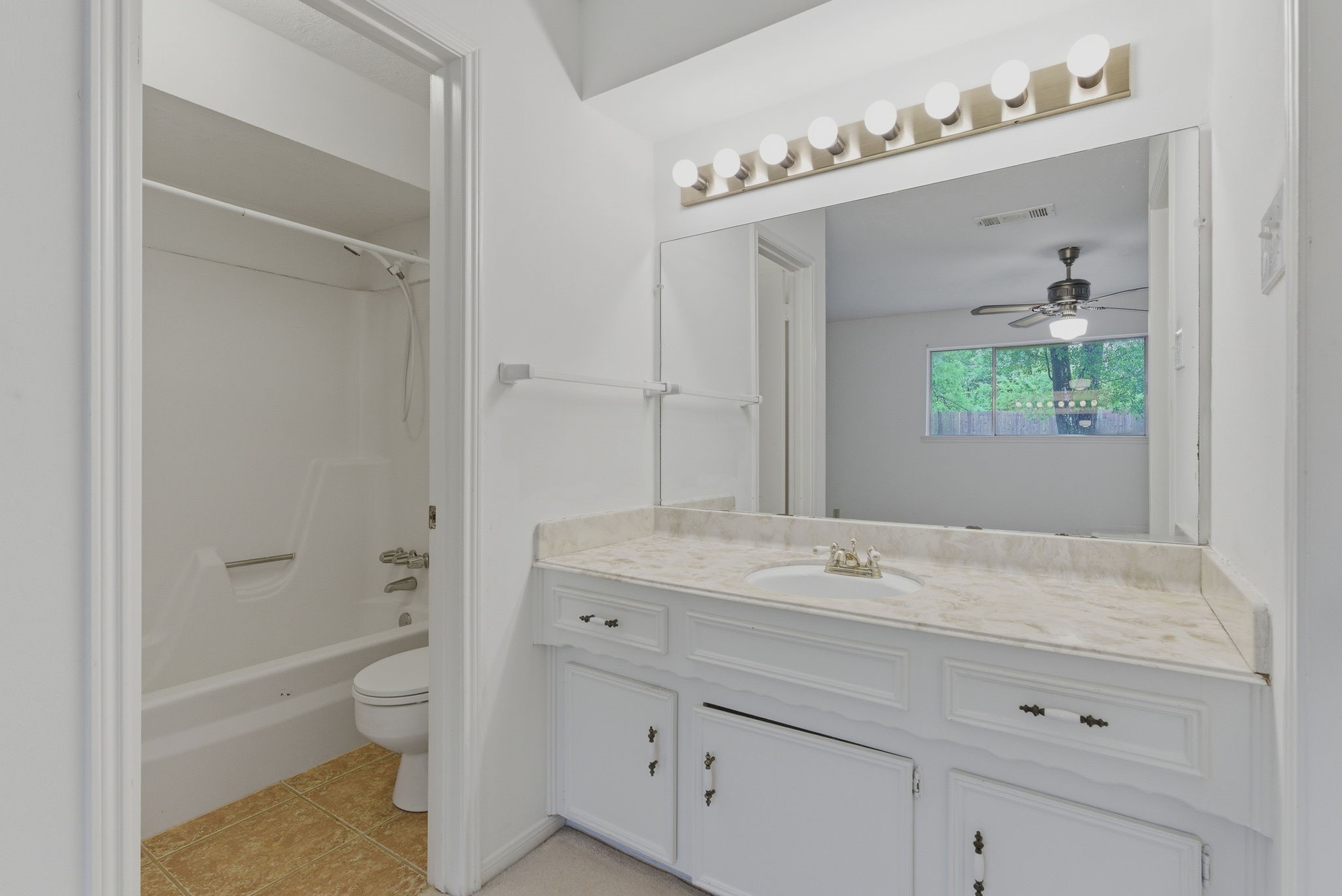 26503 Hillside Drive Spring, TX 77386 - Photo 14 of 22 a spacious bathroom with a granite countertop sink mirror and toilet
