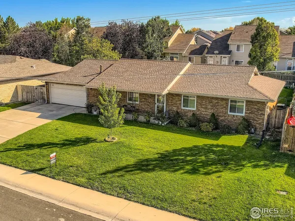 a aerial view of a house with a yard table and chairs