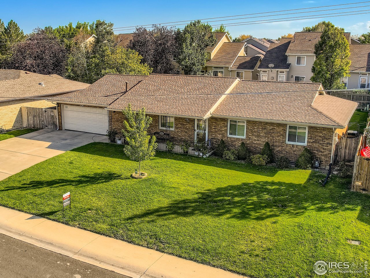 a aerial view of a house with a yard table and chairs