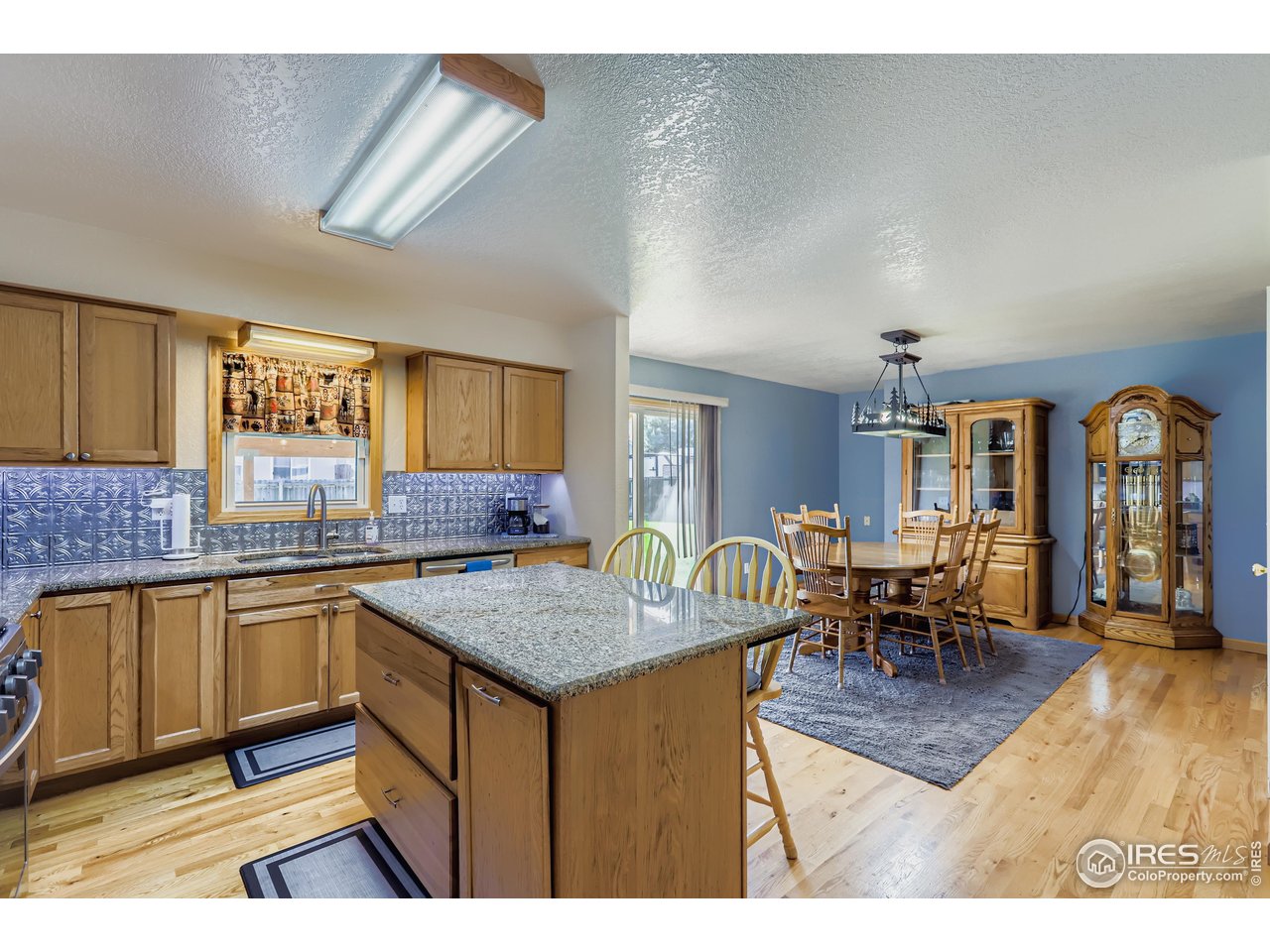 121 Chestnut Street Windsor, CO 80550 - Photo 11 of 42 a kitchen with a counter top space and dining table