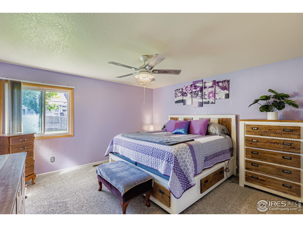 121 Chestnut Street Windsor, CO 80550 - Photo 14 of 42 a bedroom with a bed and a chandelier