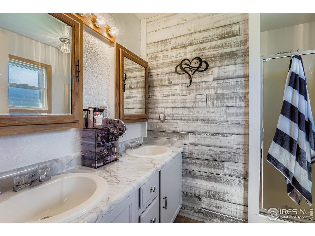 121 Chestnut Street Windsor, CO 80550 - Photo 17 of 42 a bathroom with a sink and a mirror