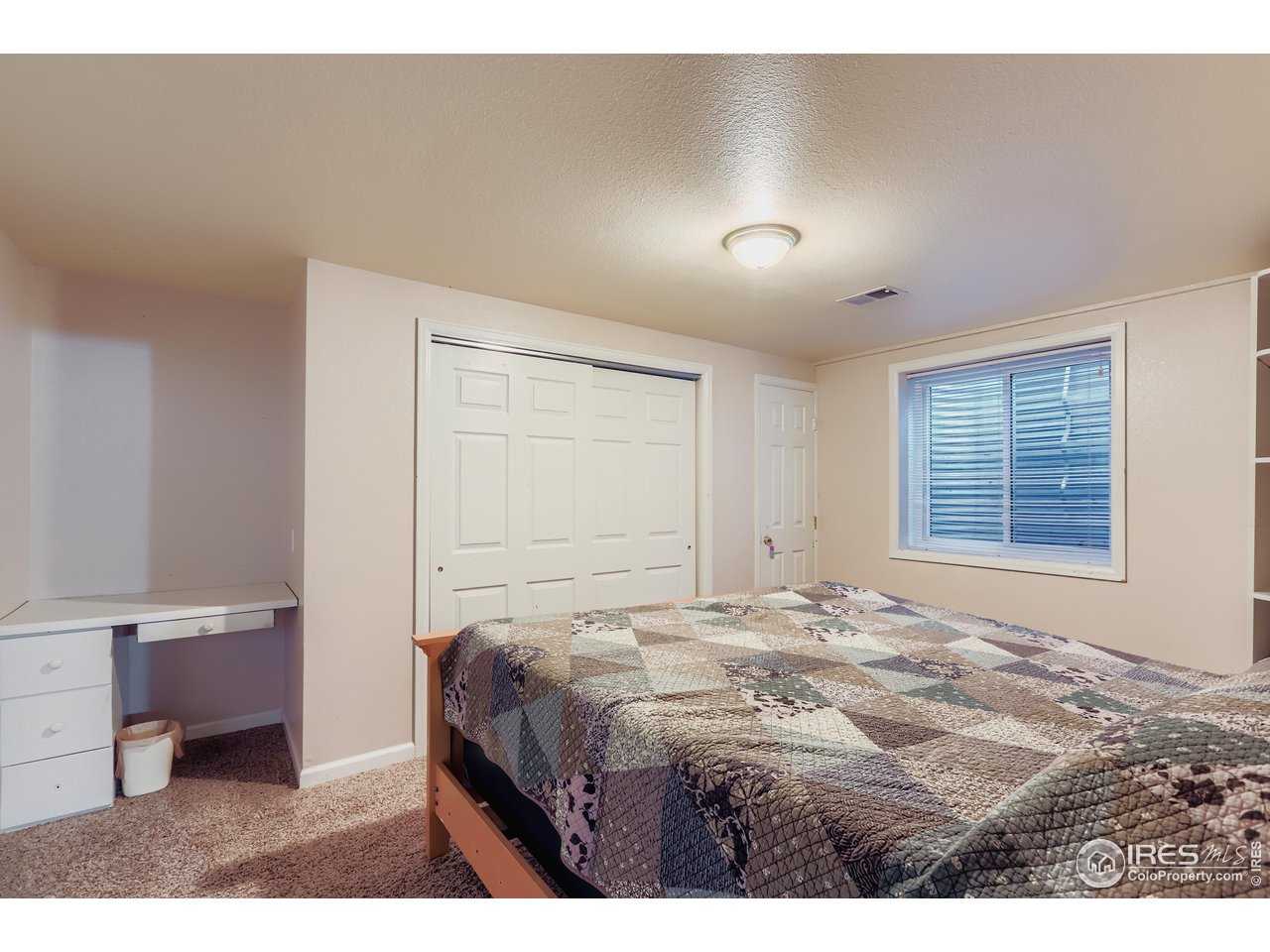 121 Chestnut Street Windsor, CO 80550 - Photo 32 of 42 a bedroom with a bed and a window