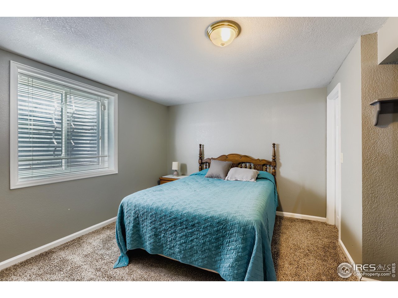 121 Chestnut Street Windsor, CO 80550 - Photo 33 of 42 a bedroom with a bed and a window