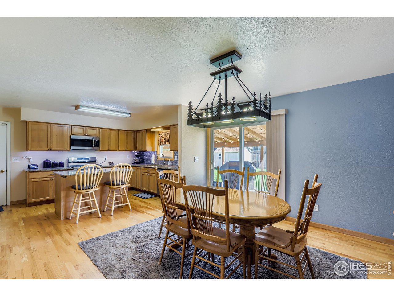 121 Chestnut Street Windsor, CO 80550 - Photo 10 of 42 a view of a dining room with furniture and wooden floor