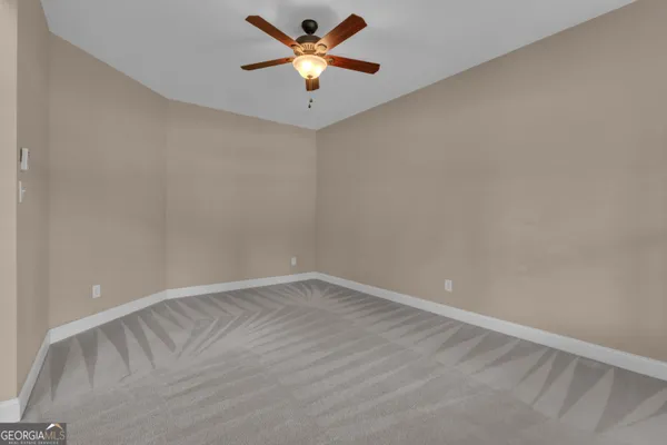a view of a livingroom with furniture wooden floor and a ceiling fan