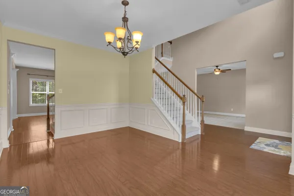 a view of entryway and hall with wooden floor