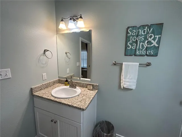 a bathroom with a granite countertop toilet sink and shower
