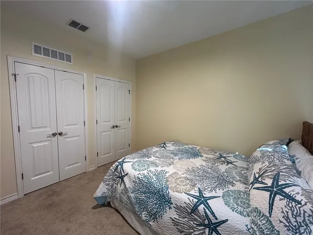 a bedroom with two beds and a chandelier