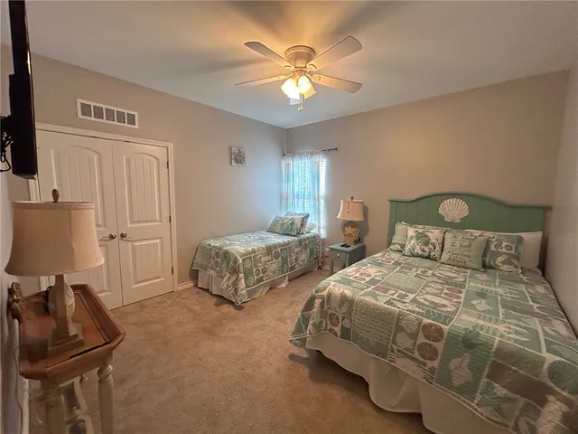 a bedroom with a bed and flat screen tv