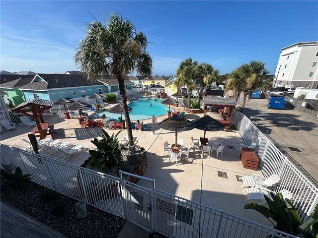 a view of a dining room with furniture and a floor to ceiling window