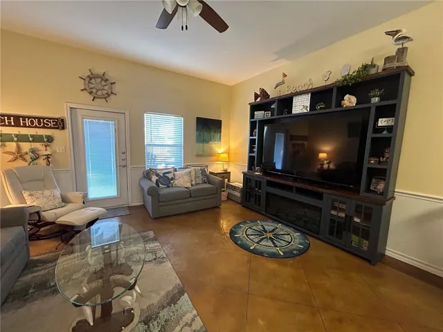 a living room with lots of furniture and kitchen view