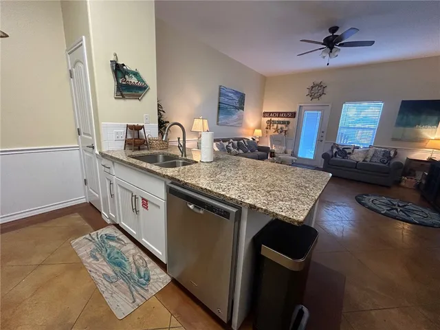 a kitchen with stainless steel appliances a refrigerator stove and microwave