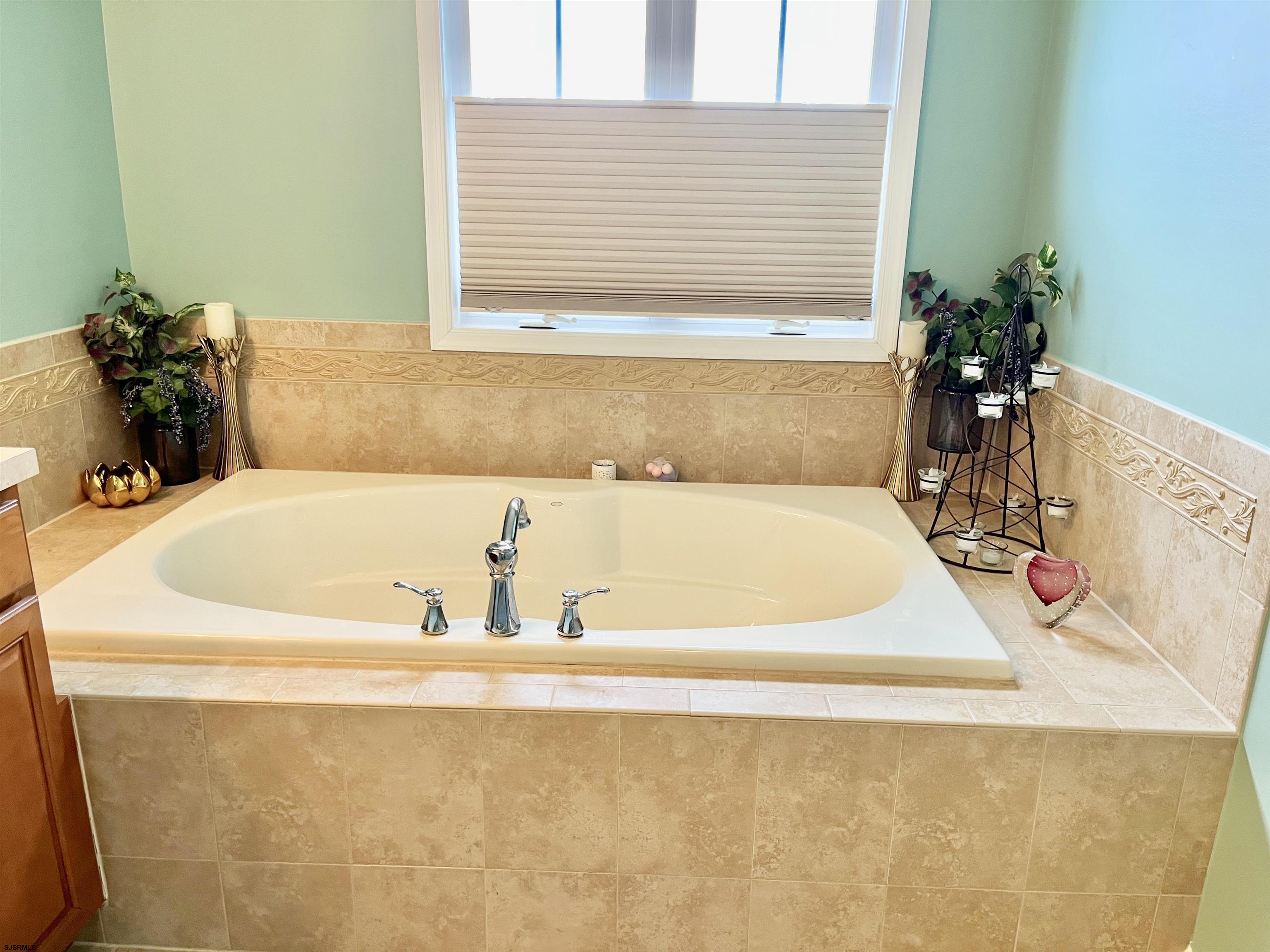 130 Dunlin Lane, Unit 16 Pleasantville, NJ 08232 - Photo 20 of 47 a bath tub sitting in a bathroom next to a window