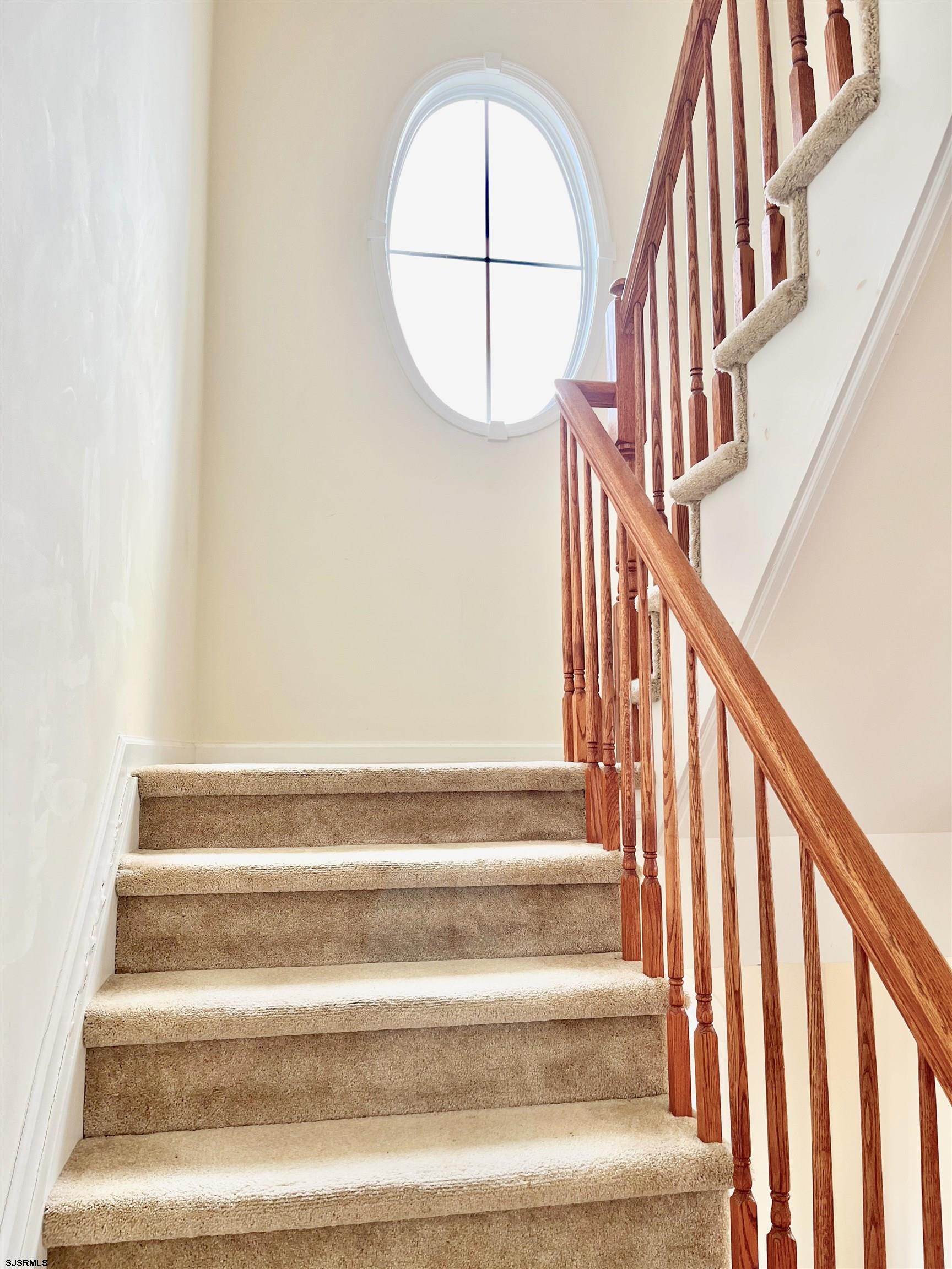 130 Dunlin Lane, Unit 16 Pleasantville, NJ 08232 - Photo 34 of 47 a view of staircase with railing and a floor to ceiling window