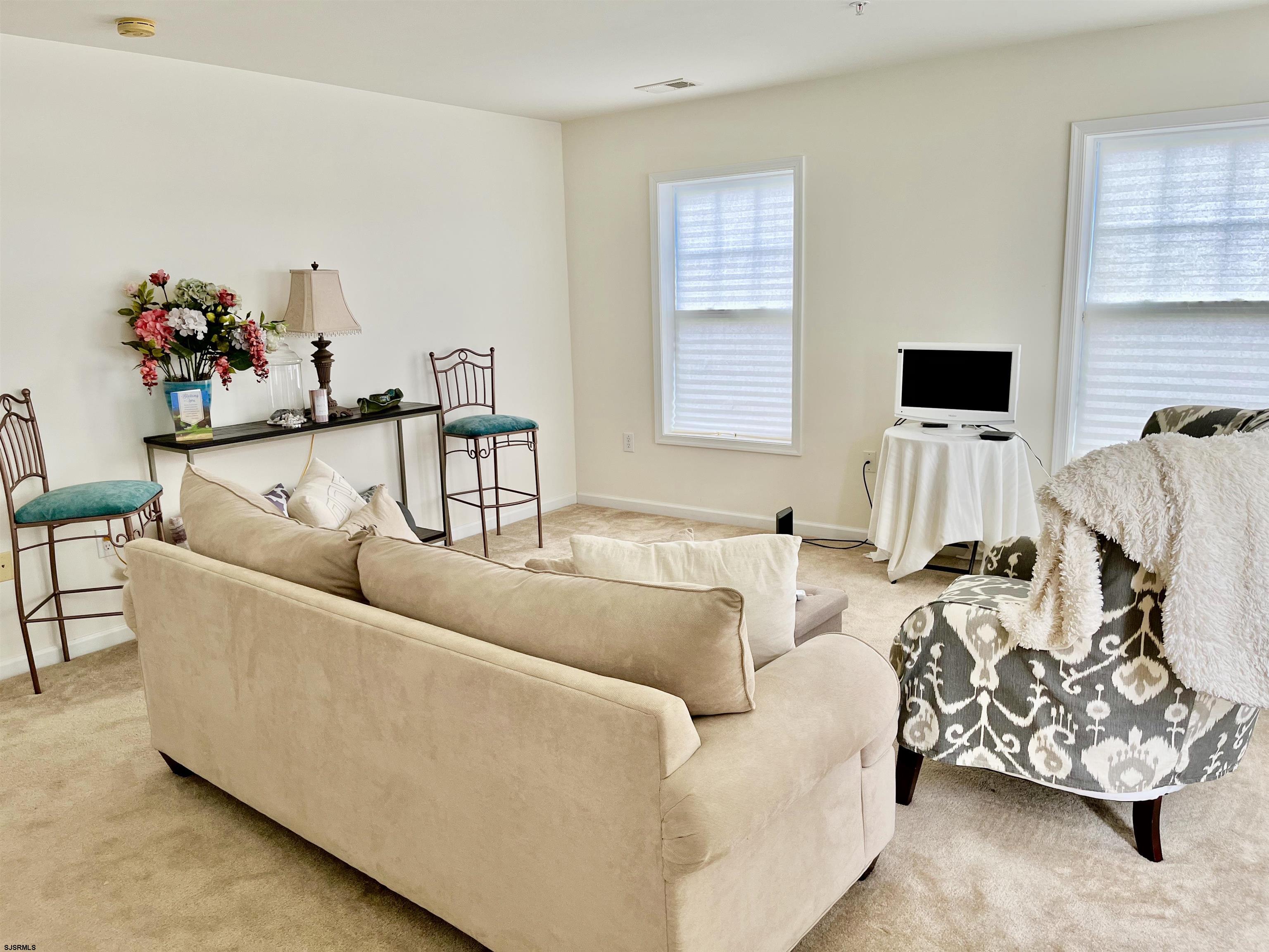 130 Dunlin Lane, Unit 16 Pleasantville, NJ 08232 - Photo 38 of 47 a living room with furniture and a flat screen tv