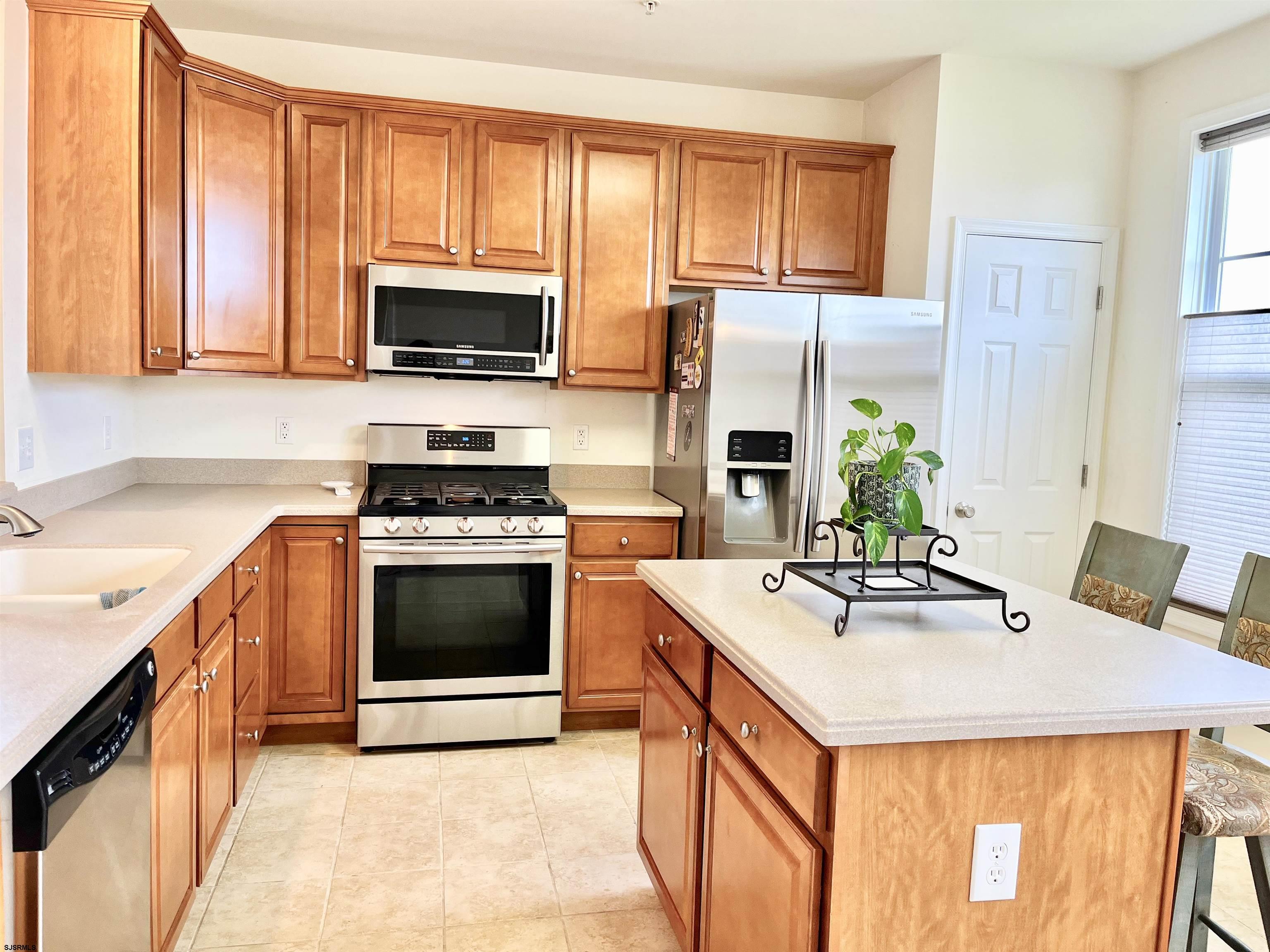 130 Dunlin Lane, Unit 16 Pleasantville, NJ 08232 - Photo 7 of 47 a kitchen with stainless steel appliances a stove sink microwave and cabinets