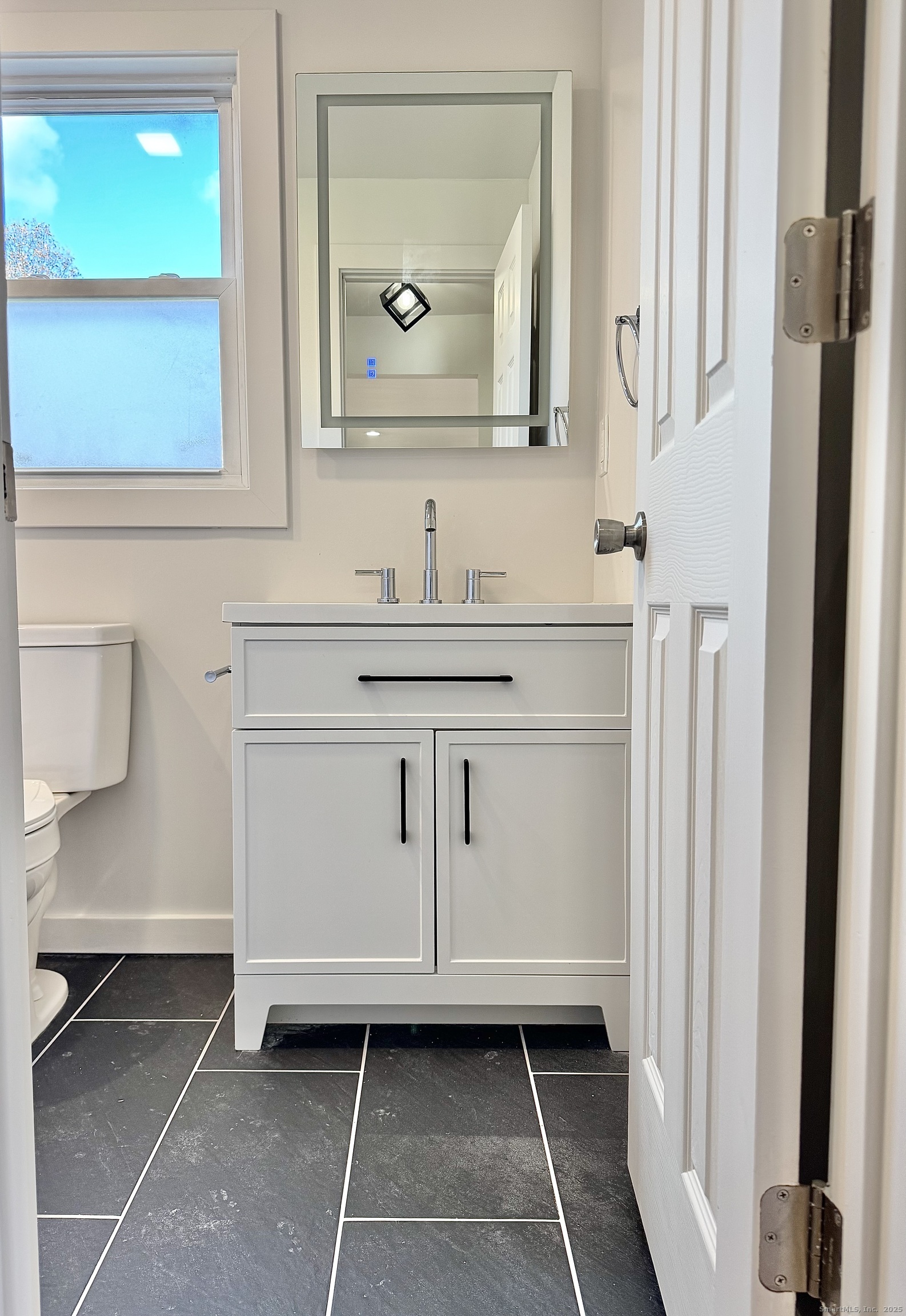 1742 Boston Post Road, Unit 3B Westbrook, CT 06498 - Photo 12 of 16 a bathroom with a sink a toilet and a mirror