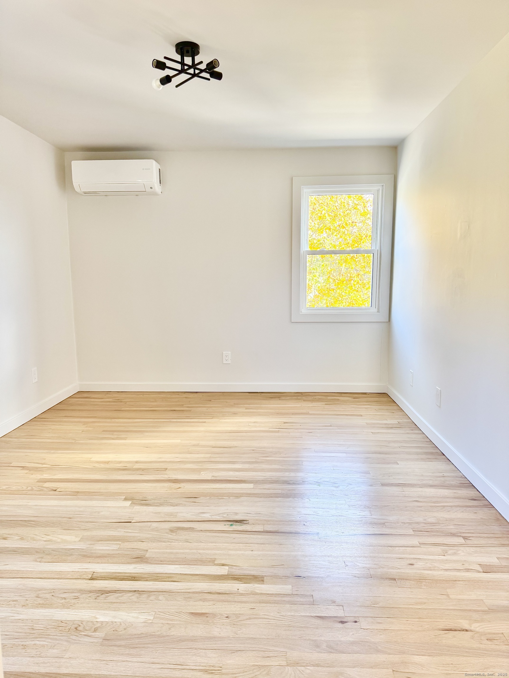 1742 Boston Post Road, Unit 3B Westbrook, CT 06498 - Photo 9 of 16 a view of an empty room with wooden floor and cabinet