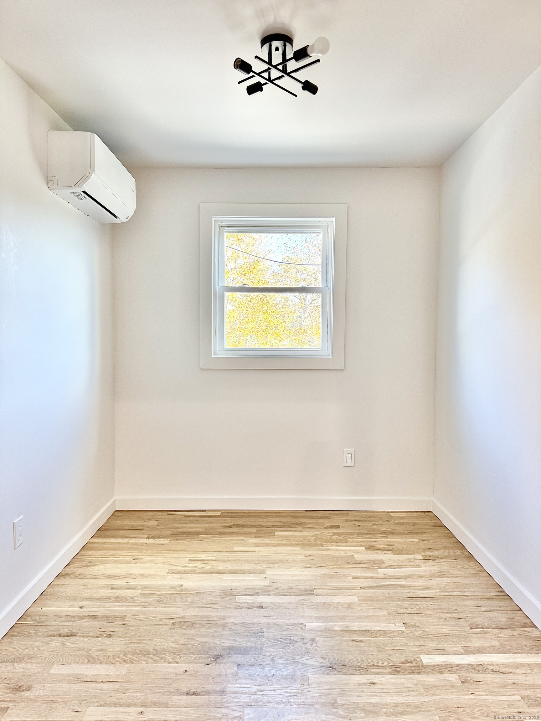 1742 Boston Post Road, Unit 3B Westbrook, CT 06498 - Photo 10 of 16 a view of an empty room with wooden floor and a window